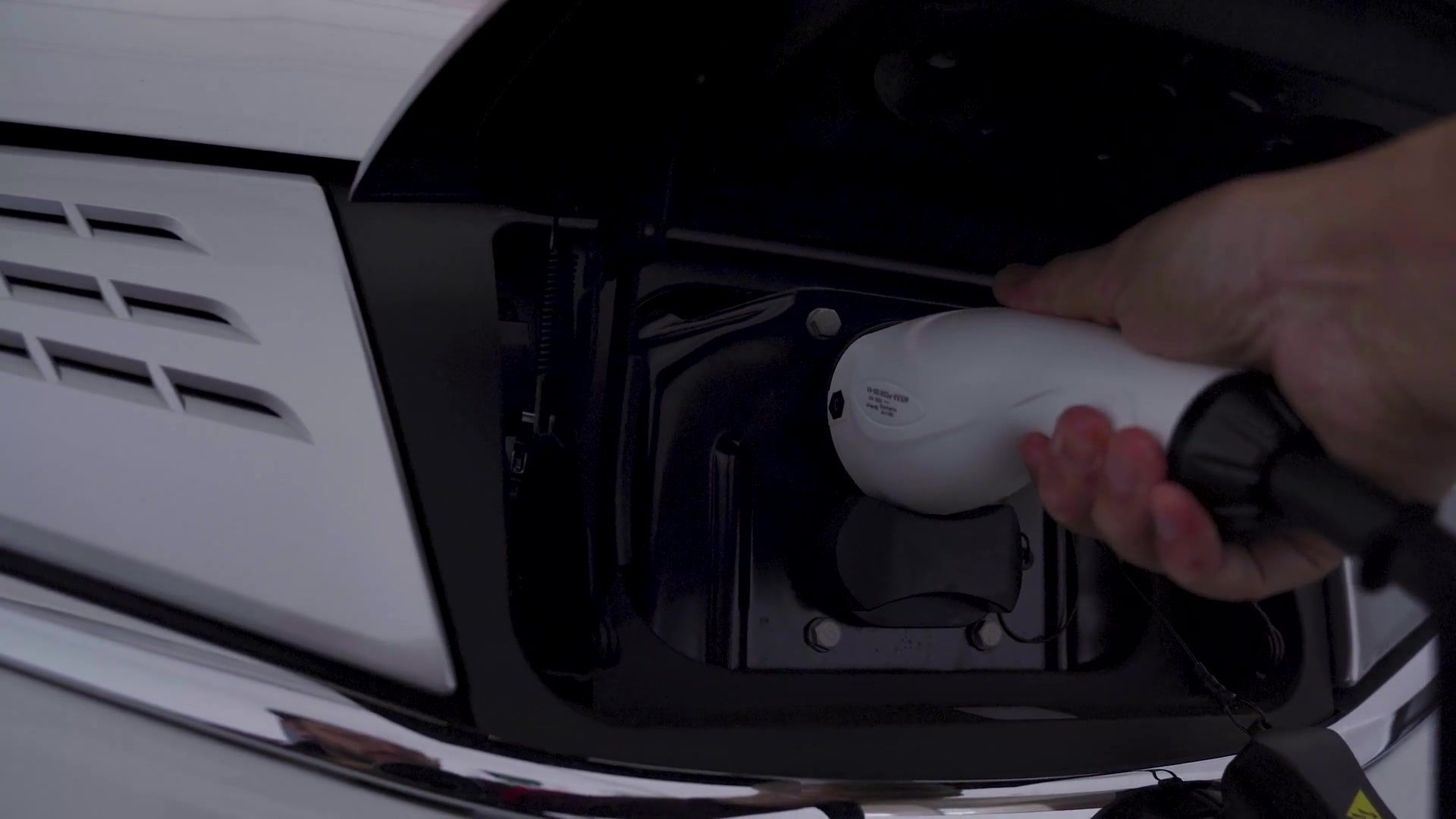 Plugging a charging connector into an electric vehicle